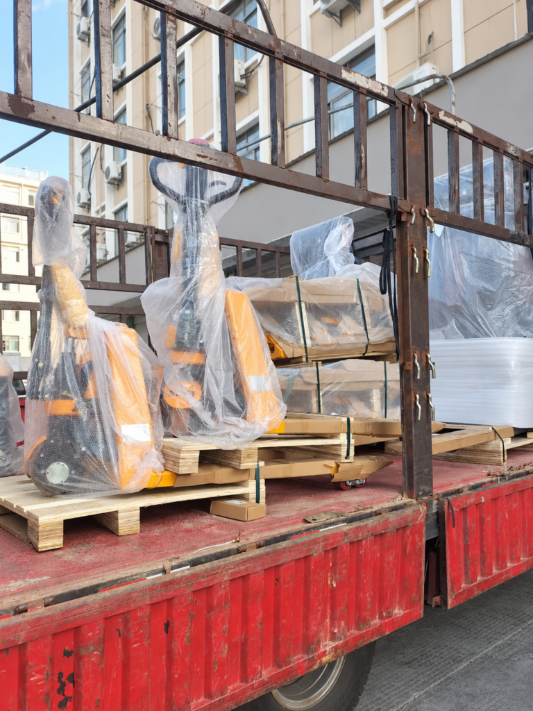 Wrapped pallet trucks secured on a truck for cargo handover